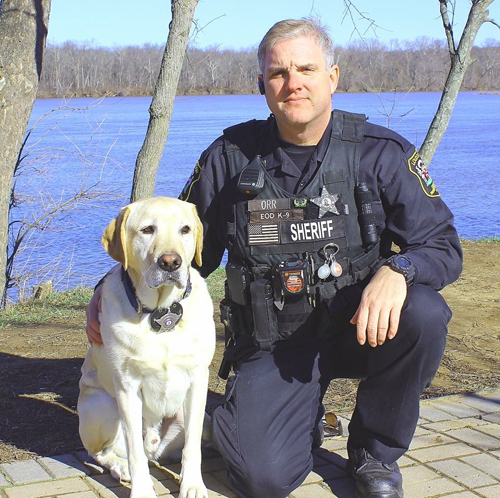 officer next to dog